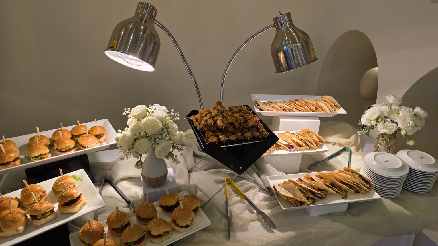 Elegant catering display with sliders, quesadillas and kebabs