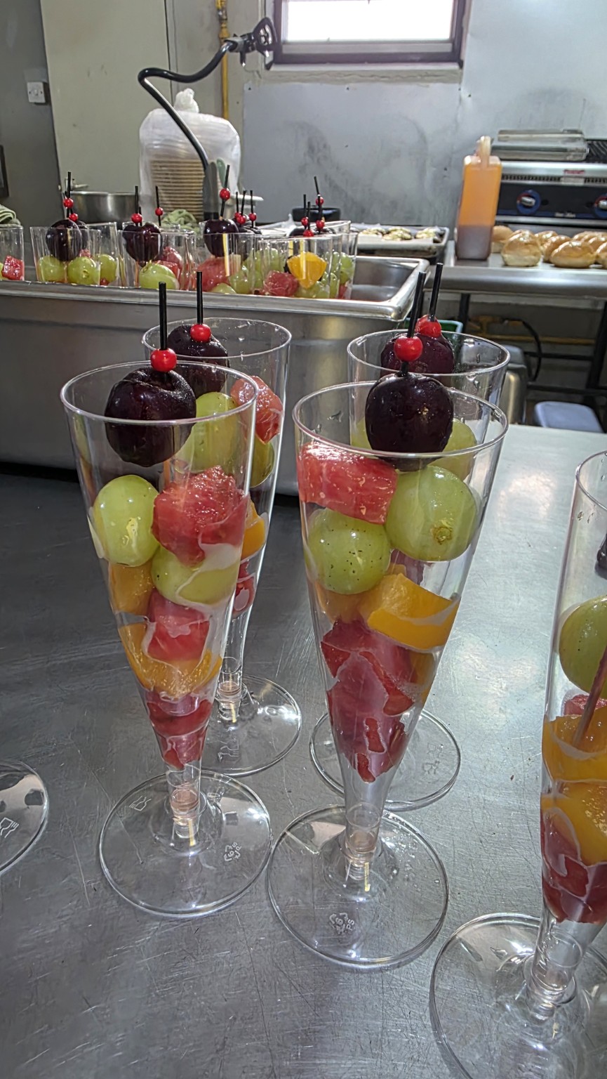 Individual fresh fruit cups prepared for an event