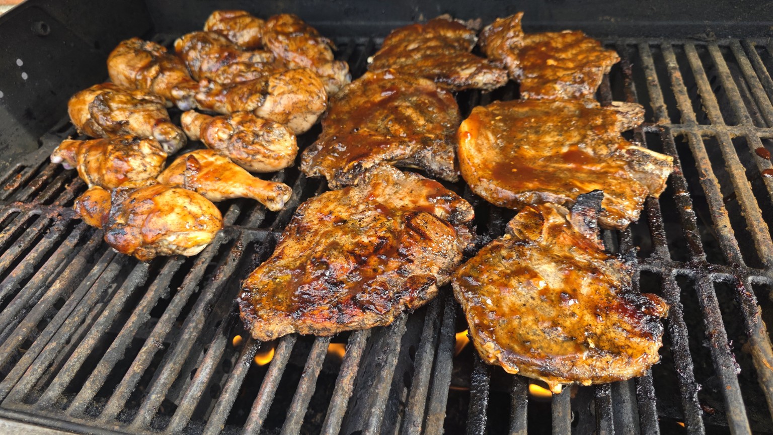 Seasoned meats cooking on a grill